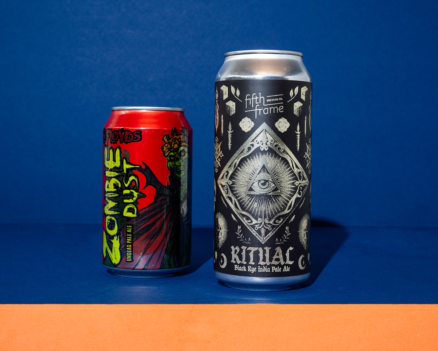 Two beer cans with a macabre design.