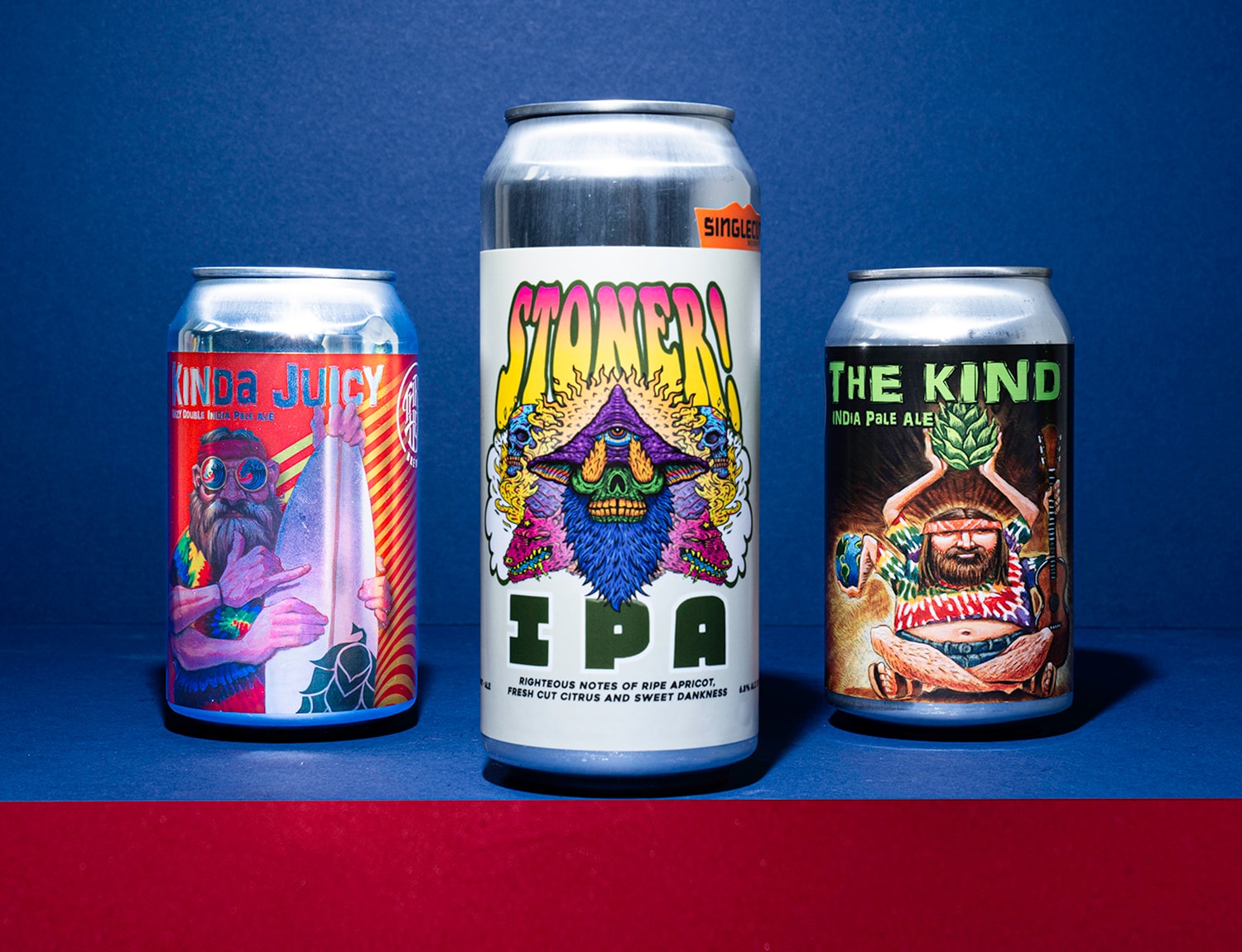 A line up of three beer cans with trippy label designs.